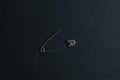 single isolated safety pin on black background Royalty Free Stock Photo