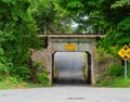 Single lane underpass road short tunnel under a railroad track. Royalty Free Stock Photo
