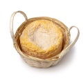 Single Langres cheese refined with champagne in a basket close up on white background