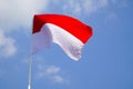 The single large red and white Indonesian flag flutters in the strong wind ahead of the 77th Independence Day.