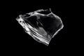 Single large transparent piece of broken glass on black background isolated abstract shape clear texture element for design with Royalty Free Stock Photo