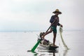 A single-legged rower with a net fishing on Inle Lake, Myanmar, April 12th, 2018 Royalty Free Stock Photo