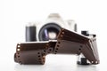 Single lens reflex camera and a film roll on white background Royalty Free Stock Photo