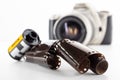 Single lens reflex camera and a film roll on white background Royalty Free Stock Photo