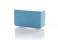 A single light blue yoga block positioned on a clean white background with a subtle reflection isolated on white background Royalty Free Stock Photo