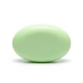 A single light green oval-shaped soap bar resting on a white background Royalty Free Stock Photo