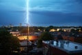 a single lightning bolt striking an antenna on a city rooftop