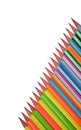 Single line of different colored wood pencil crayons placed on a white paper background Royalty Free Stock Photo