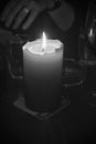 A single candle in grayscale