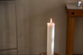 Single lit candle light in a church.. Royalty Free Stock Photo