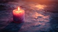 A Single Lit Candle Sits On A Dark Surface Royalty Free Stock Photo
