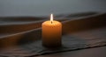 A single lit candle stands on Royalty Free Stock Photo
