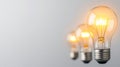Illuminated light bulb rising above unlit counterparts, representing breakthrough thinking and innovative leadership Royalty Free Stock Photo