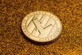 Single litecoin coin on golden glittering background
