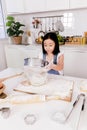 Single little sister sift the flour in the kitchen