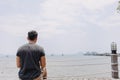 Single lonely man sitting alone looking out to the sea bay. Royalty Free Stock Photo