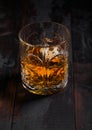 Single malt scotch whiskey in crystal glass on dark wooden background Royalty Free Stock Photo