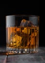 Single malt scotch whiskey in crystal glass with ice cubes on wooden background Royalty Free Stock Photo