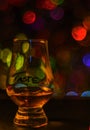 Single malt tasting glass, single malt whisky in a glass, bokeh Royalty Free Stock Photo