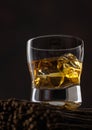 Single malt whiskey in glass with ice cubes on top of wooden planks Royalty Free Stock Photo