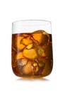 Single malt whiskey in large luxury crystal glass with ice cubes on white background