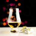 Single malt whisky in tasting glass on christmas background, co Royalty Free Stock Photo