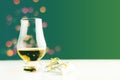 Single malt  whisky in tasting glass on christmas background, colorful bokeh Royalty Free Stock Photo