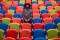 Stylish African man inside auditorium with colorful seating