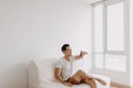 Single man playing with his sugarglider pet alone in his apartment.