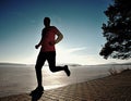 Single man running workout, excercise for run near frozen lake