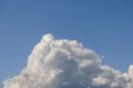 A single, massive cumulus cloud, mountain-shaped, originates from the lower part of the photograph