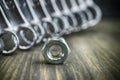 Single metal nut from a bolt with set of spanners Royalty Free Stock Photo