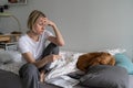 Single middle-aged woman sits on bed and regrets about increased living cost closeup Royalty Free Stock Photo