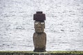Single Moai statue with eyes over the ocean