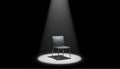 Single Modern Chair Under Bright Spotlight in Dark Studio for Dramatic Concept Scene Royalty Free Stock Photo