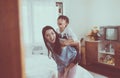 Single mom and daughter on a piggy back ride,Happy and smiling,Funny girl