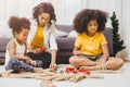 Single mom living with two daughter learning and playing puzzle toy in home apartment. Nanny looking or childcare at living room Royalty Free Stock Photo