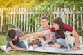 Single mom and sons play guitar together in the park