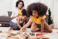 Single mom with two daughter playing toy in apartment. Nanny looking or childcare at home black people