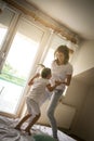 Single mother having fun on bed with her daughter. Royalty Free Stock Photo