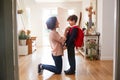 Single Mother At Home Getting Son Wearing Uniform Ready For First Day Of School Royalty Free Stock Photo