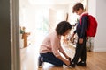 Single Mother At Home Getting Son Wearing Uniform Ready For First Day Of School Royalty Free Stock Photo