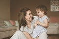 Single mother playing with her little baby at home. Royalty Free Stock Photo