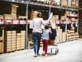 Single mother shopping at IKEA furniture store pushing cart