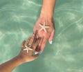 Single Mother and son watching starfish. Positive human emotions, feelings, joy. Funny cute child making vacations and enjoying Royalty Free Stock Photo