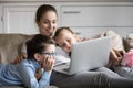 Single mother and two kids watching movie on laptop