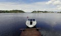 Single motorboat tied to dock in Oslo Fjord. Royalty Free Stock Photo