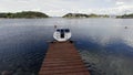 Single motorboat tied to dock in Oslo Fjord. Royalty Free Stock Photo