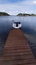 Single motorboat tied to dock in Oslo Fjord. Royalty Free Stock Photo