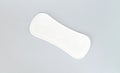 Natural daily sanitary pad or pantyliner top view on gray background